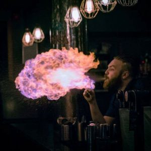 A man blowing fire at the bar in one of the top 10 Newcastle bars, Popolo