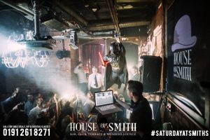 House of Smith Bar Review, with an image of people on the dance floor at House of Smith as a dwarf dressed as Darth Vader flies over the DJ booth