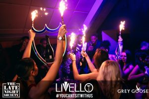 Some people carrying sparklers and alcohol in Livello nightclub